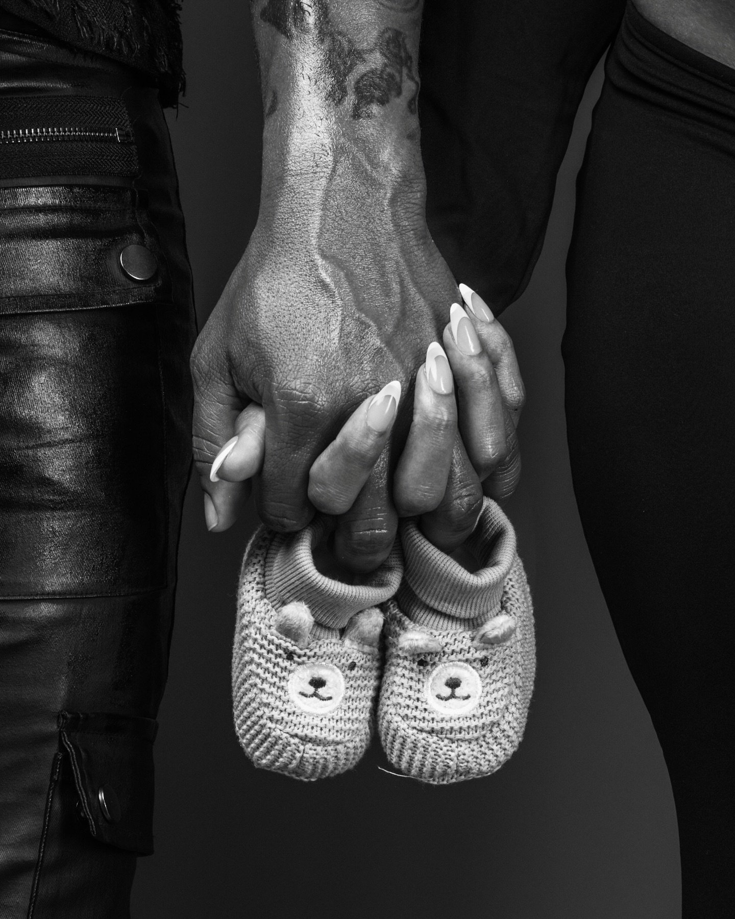Man and woman holding hands in pregnancy announcement photo taken at 11th Hour Studios in Columbia, MD