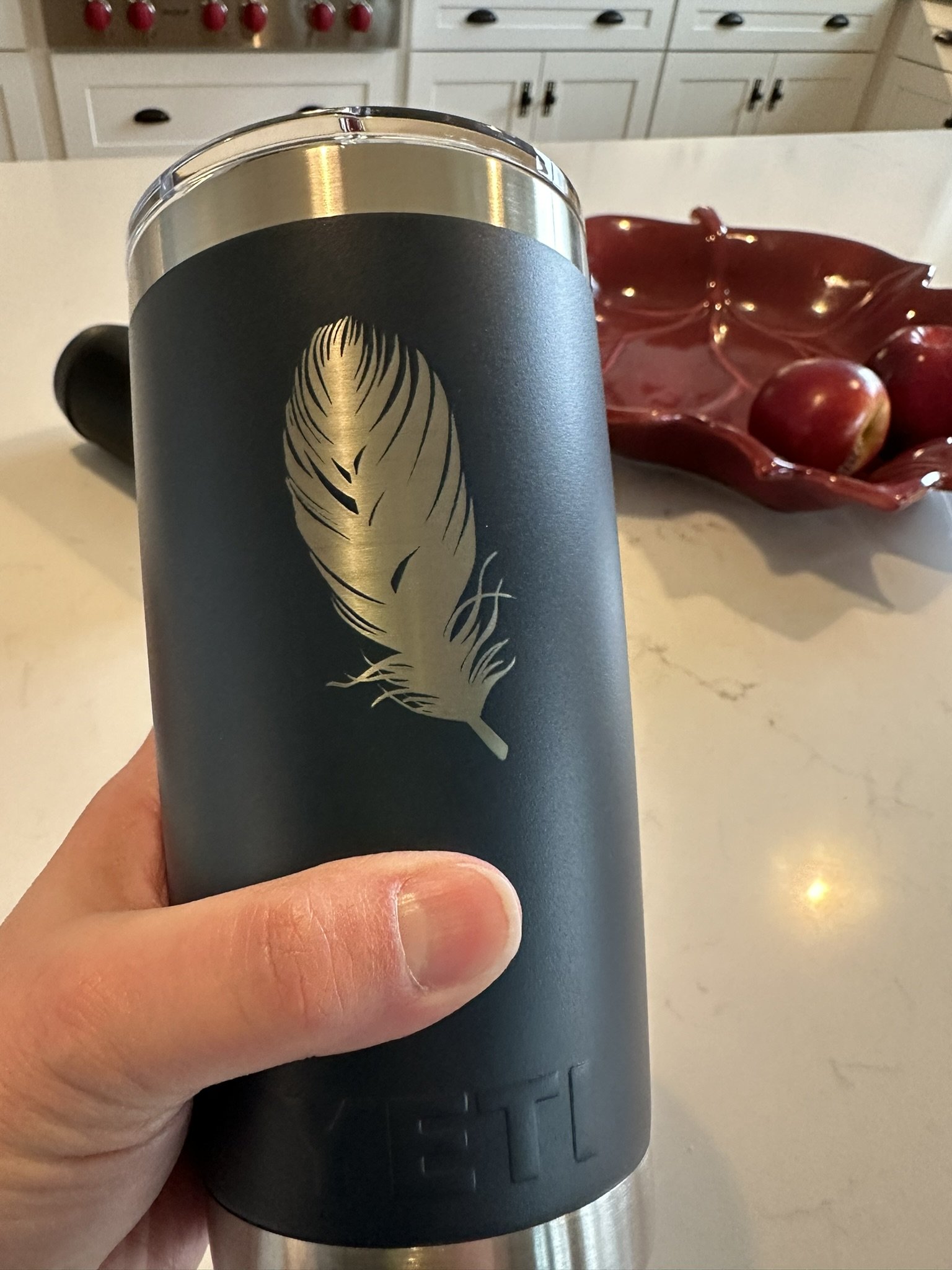 Yeti coffee tumbler engraved with a feather; a gift from Val's client