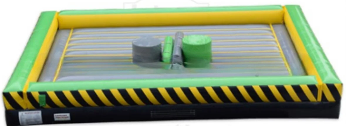 Inflatable mechanical game with green and yellow padding and a sliding hammer mechanism for knocking down targets.