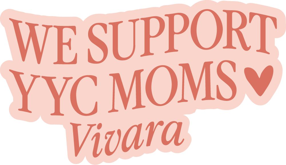 Woman holding a newborn baby close to her chest while sitting on a couch.