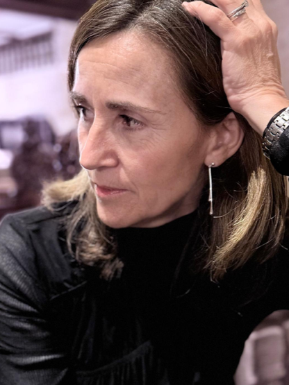 Logo with black, orange, and white colors, featuring an abstract design.