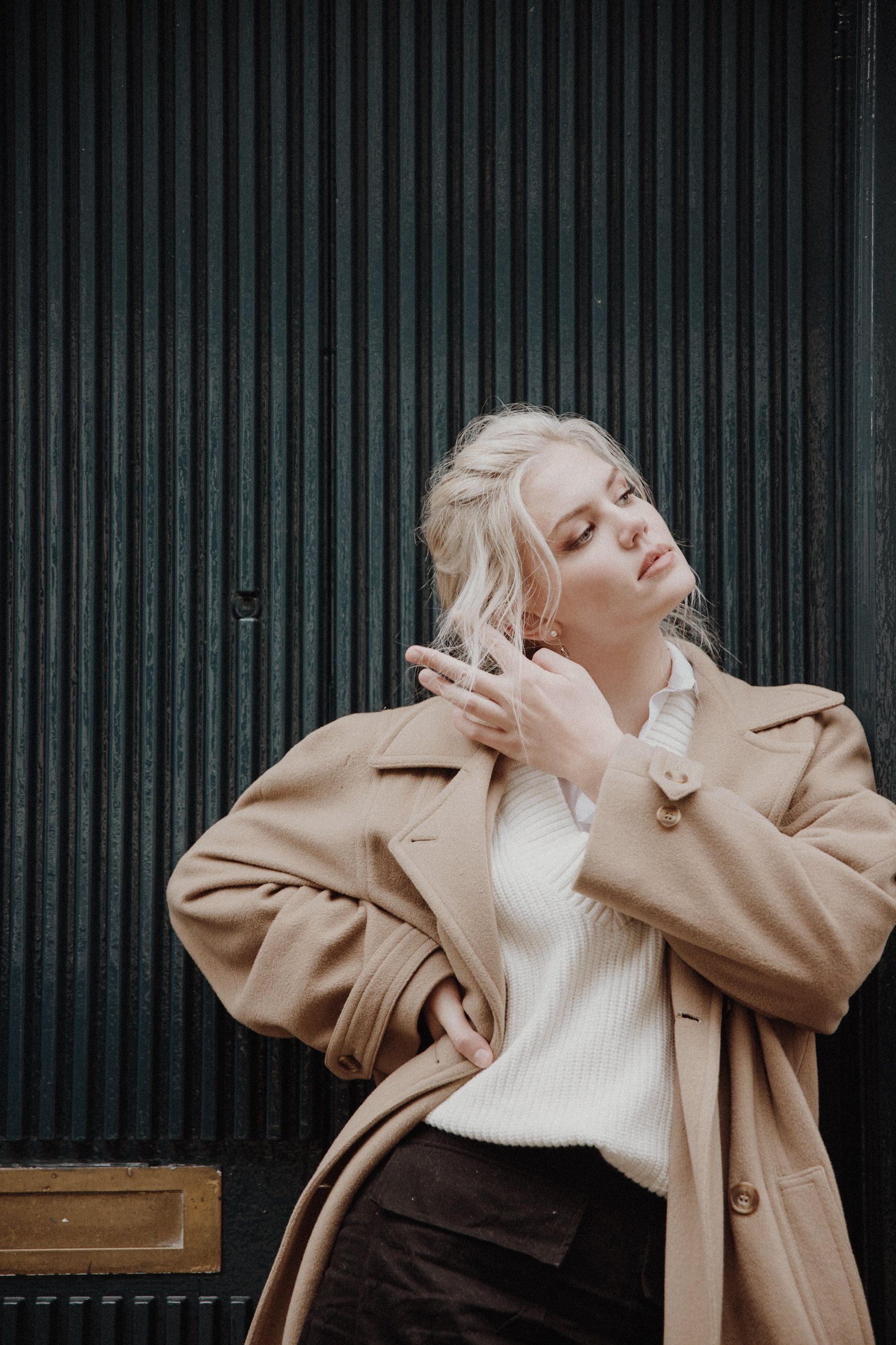  Headshot photos Edinburgh New Town with model leaning on a wall and a dark blue door background 