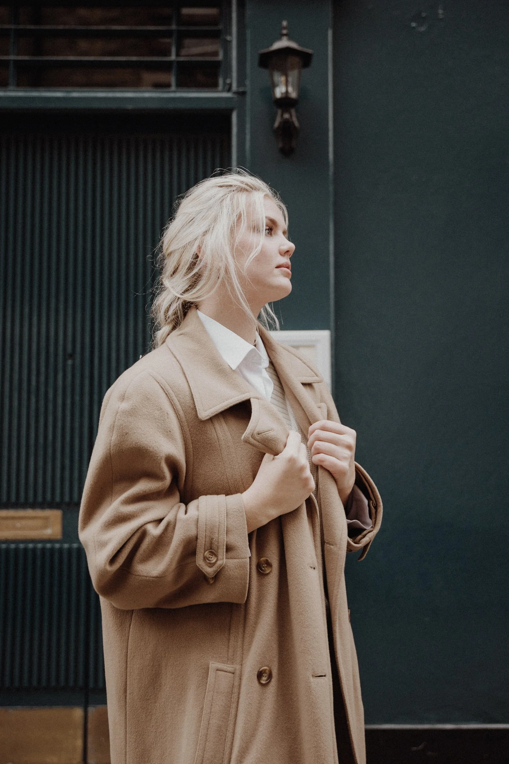  Headshot photos Edinburgh New Town with model leaning on a wall and a dark blue door background 