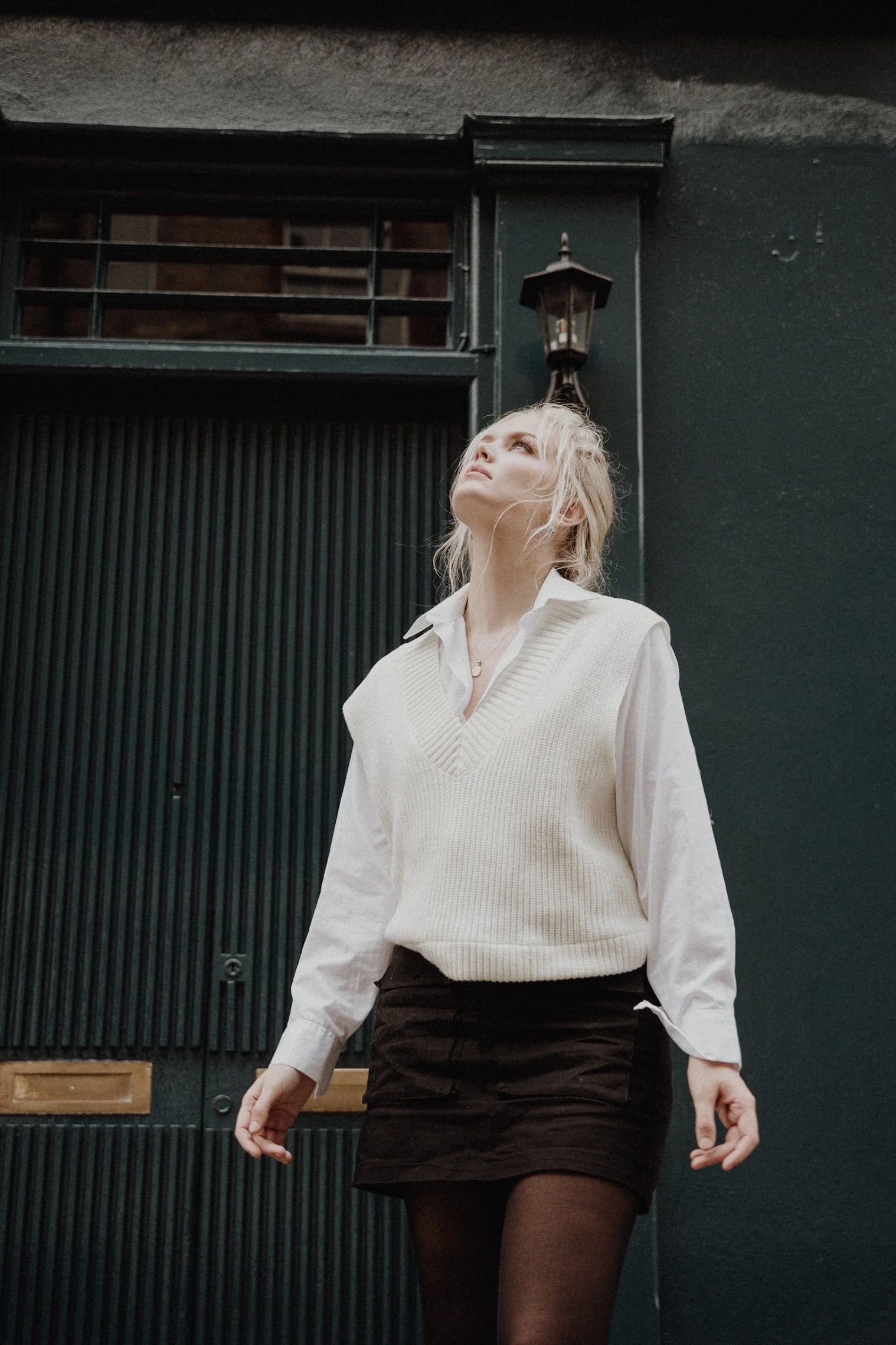  Headshot photos Edinburgh New Town with model leaning on a wall and a dark blue door background 