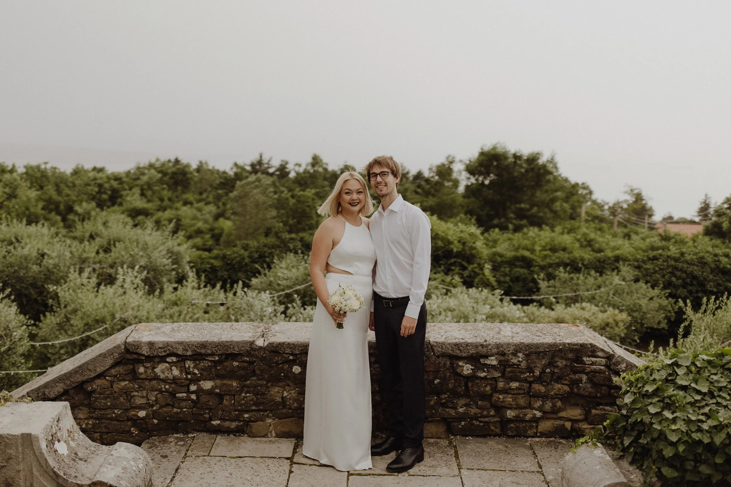 Couple embracing each other on the balcony overlooking the sea in the garden at Villa Bonomo in Trieste Italy