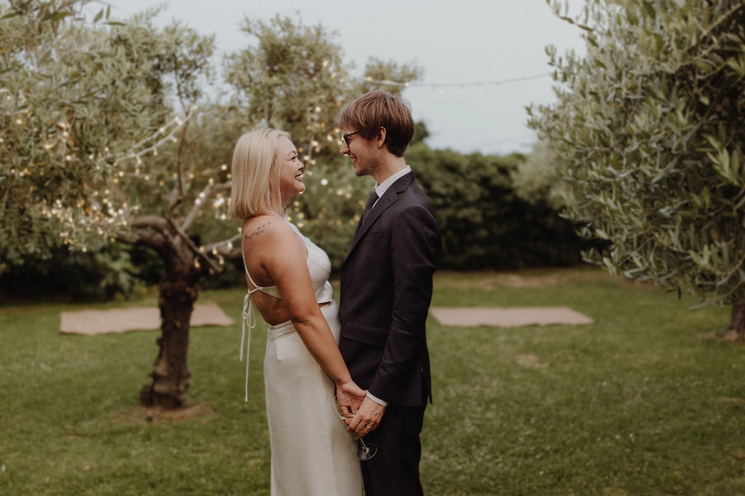 bride and groom amidst olive trees in the secret garden under villa Bonomo