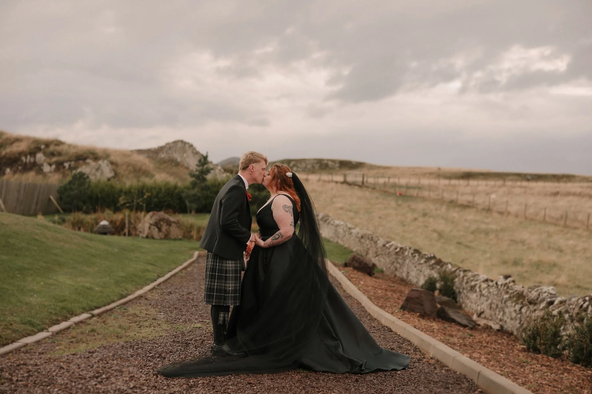 kilted groom and bride in black wedding dress scotland wedding