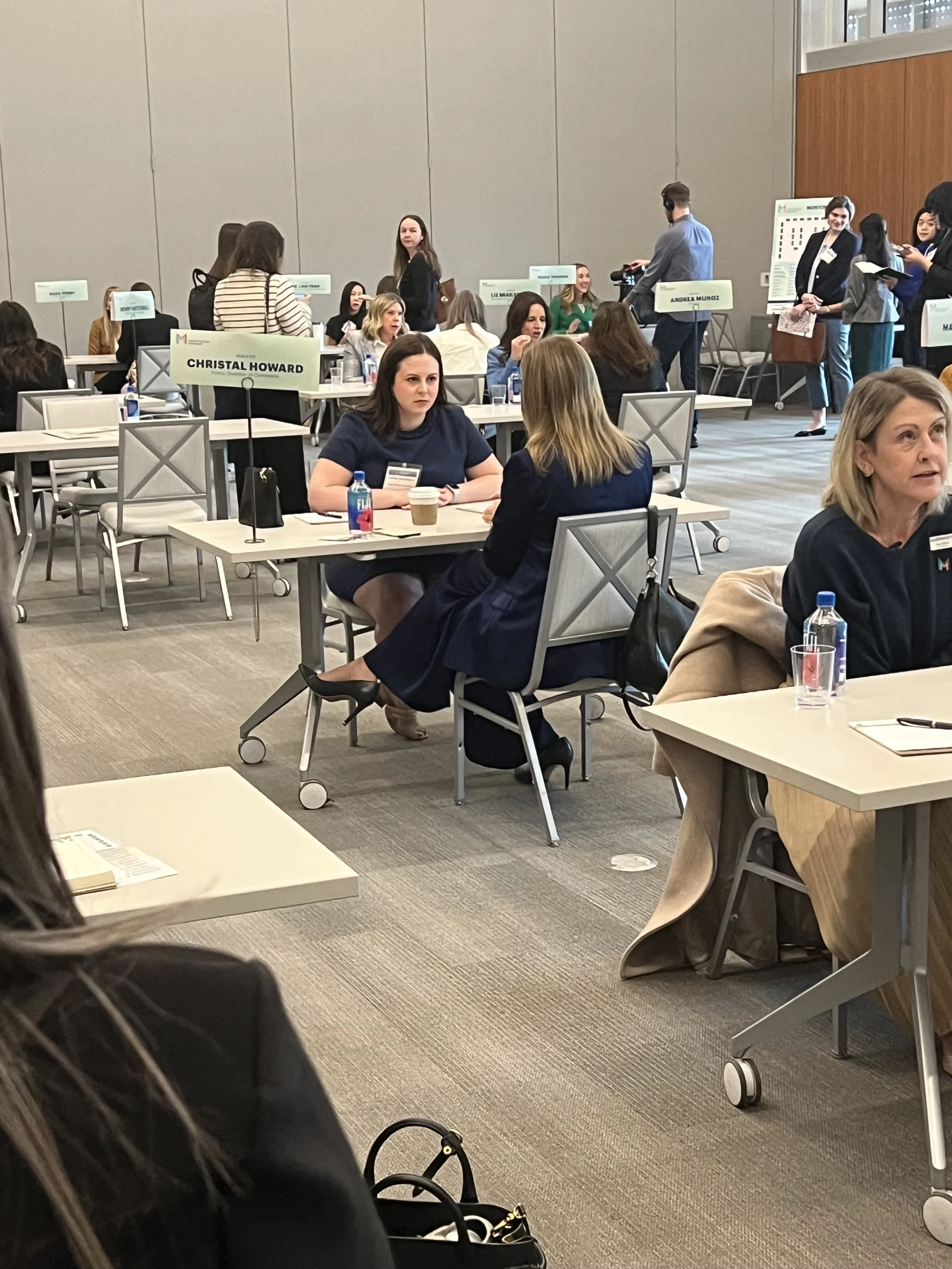 Alt Text: Aubrey Richardson, therapist and founder of Sage Holistic Counseling, leading a discussion in a classroom setting about burnout and emotional responsibility for high achieving women.