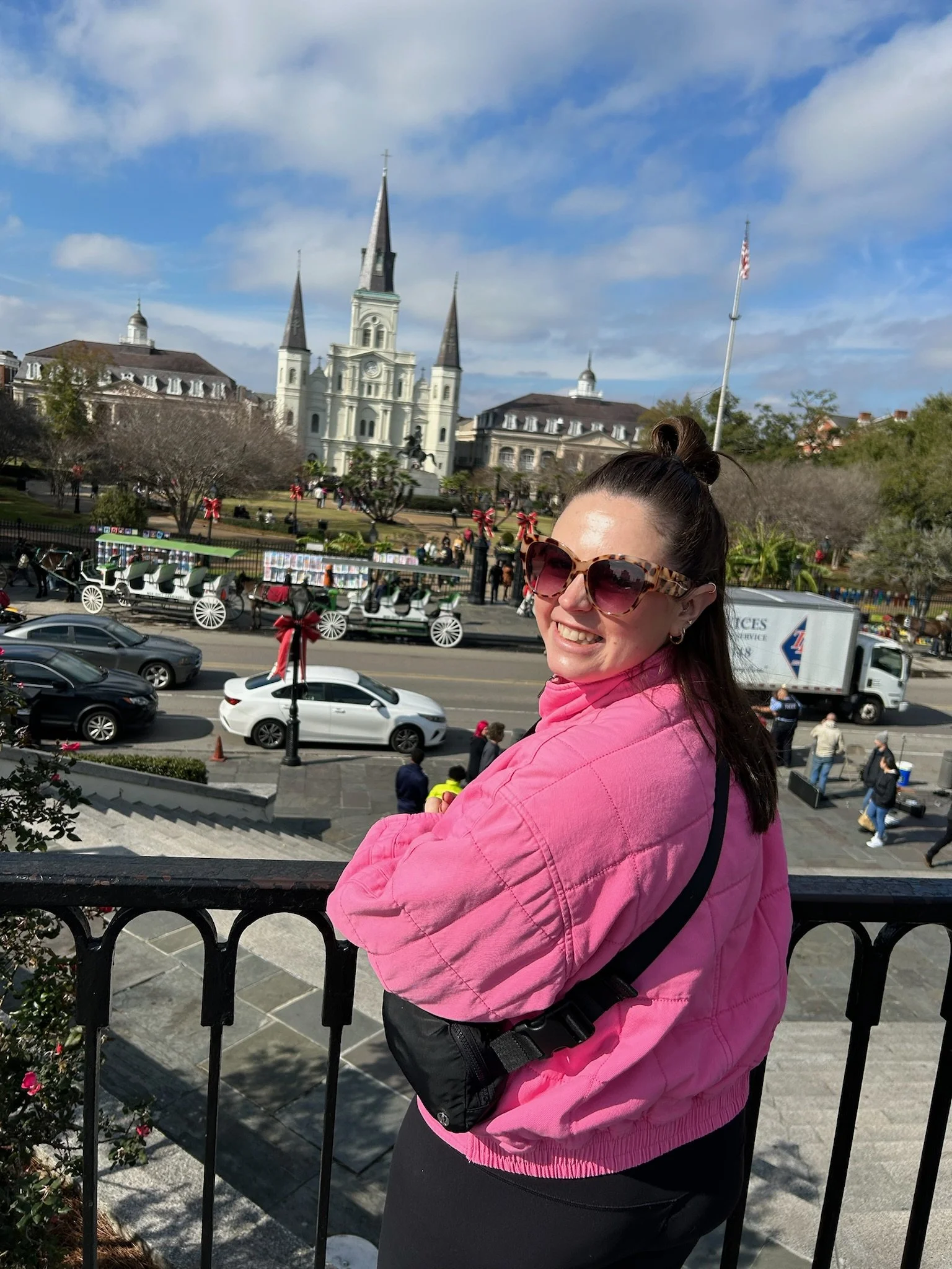 Woman smiling in front of a historic city landscape, representing confidence and self-trust after recognizing patterns of overfunctioning and emotional imbalance in relationships