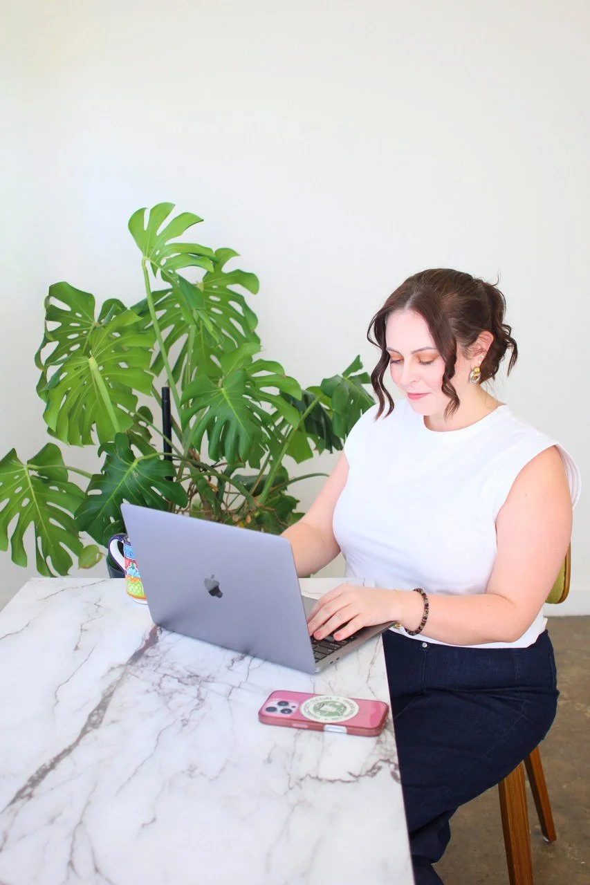Aubrey Richardson, LPC, working at her computer at Sage Holistic Counseling
