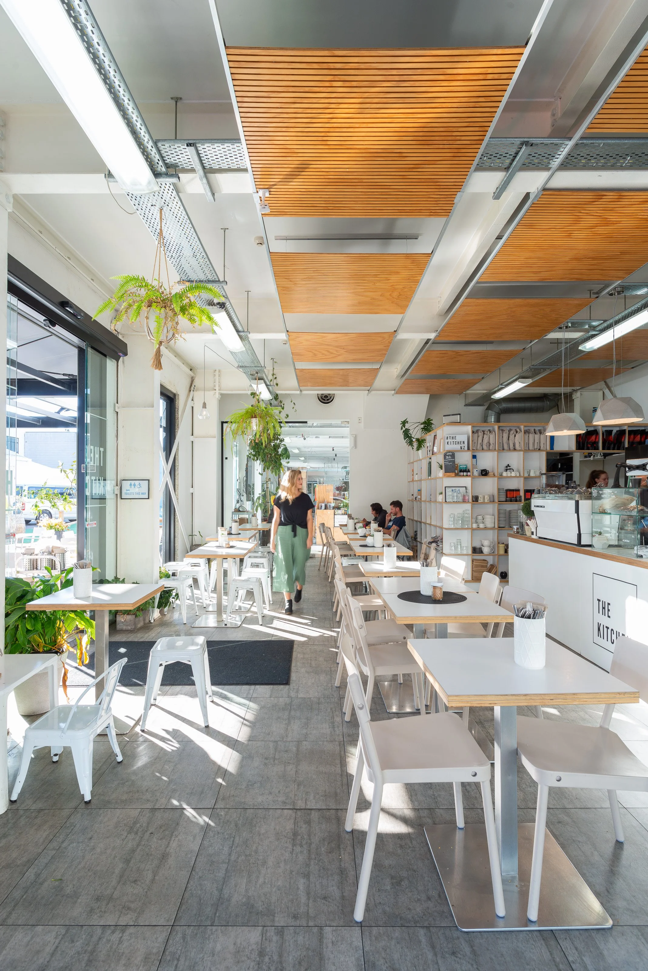 Cafe space at the front of collective office space, opened up with large doors on western aspect for seating in afternoon sun