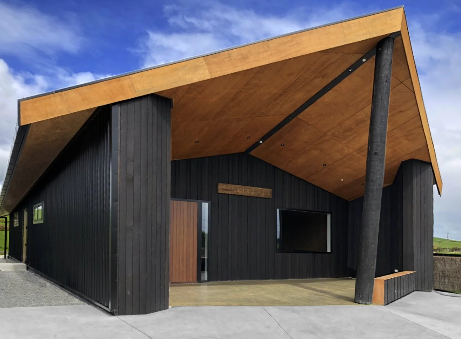Front of Matahuru Meeting house in Waikato, mixture of ply and cedar, angulated poutuaroro (front pole) to support angulated gable end