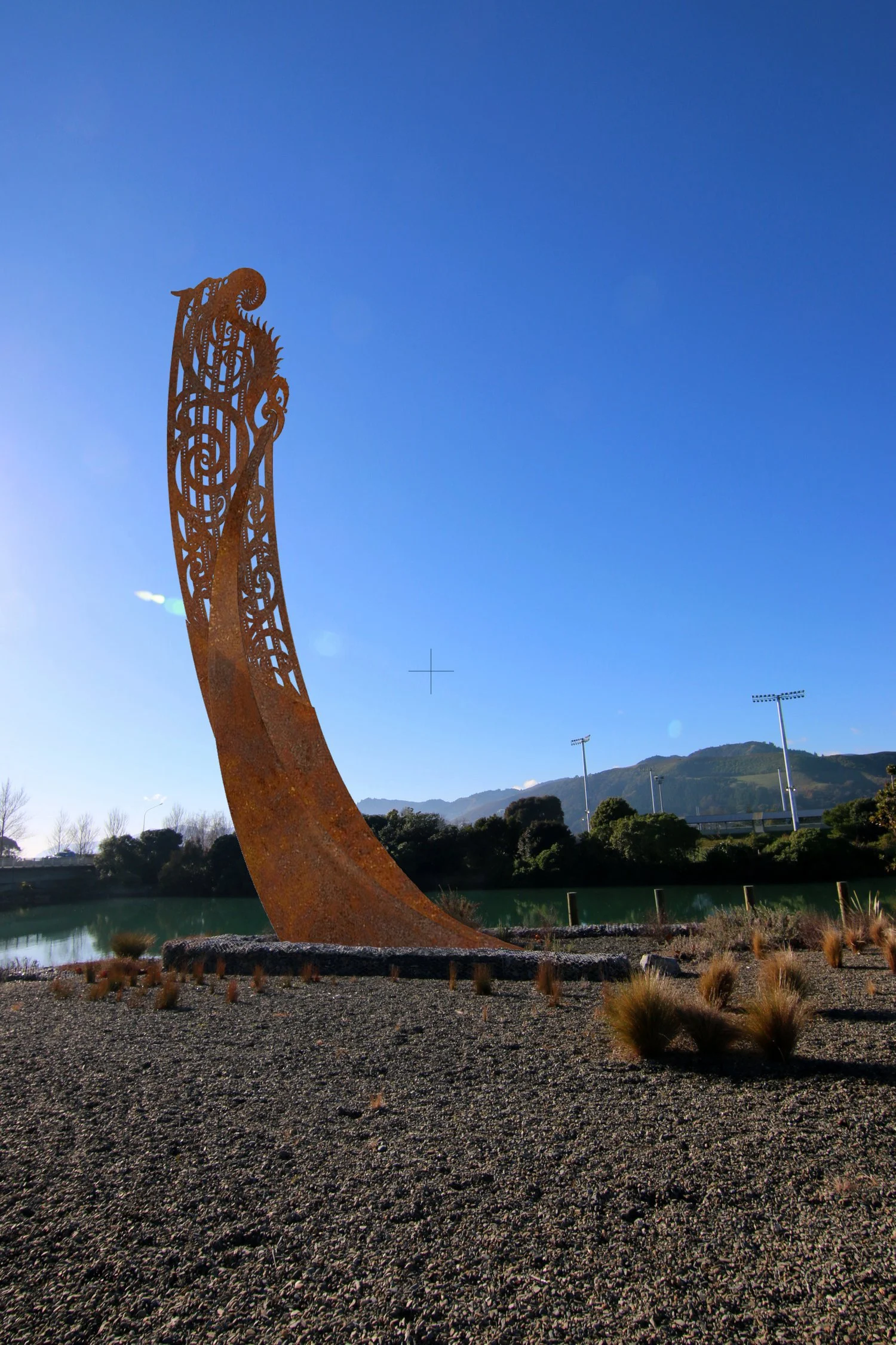 Cortin steel sculpture of Taupara (Waka prow) designed by artist Maia Heggland and refined detailing for steel-cutting by architectural designer Keni-Duke Hetet, twilight picture on still Nelson day