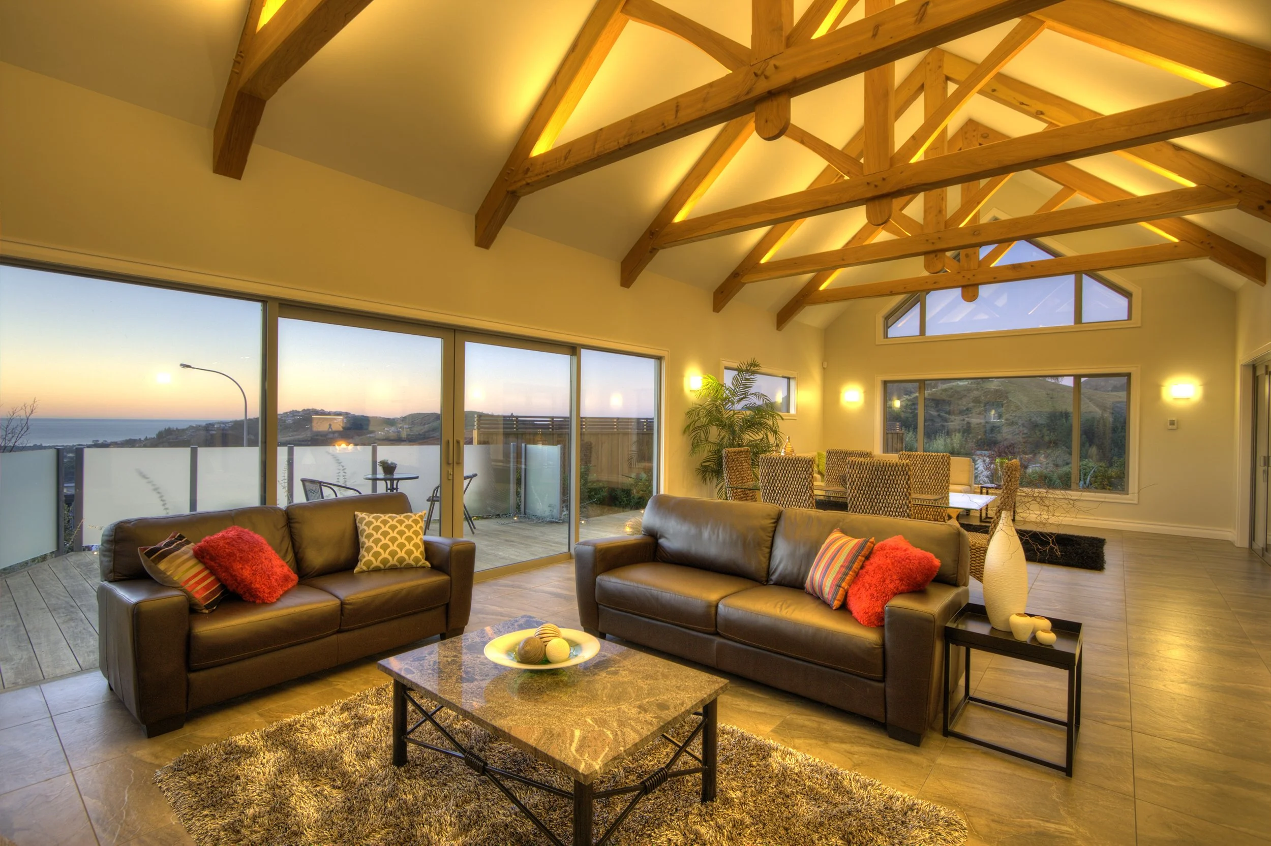 Dusk image of large stackers, exposed wooden trusses, designed by Architect Keni-Duke Hetet