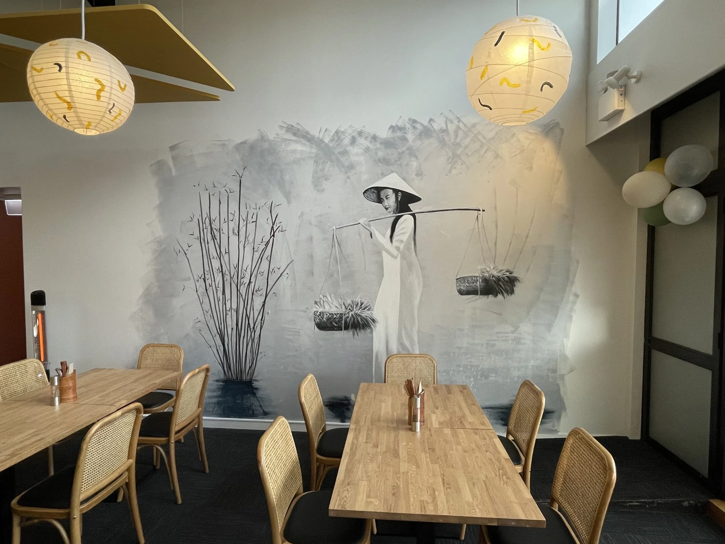 Beautiful wall mural and subtle lighting creating comfortable dining space in restaurant