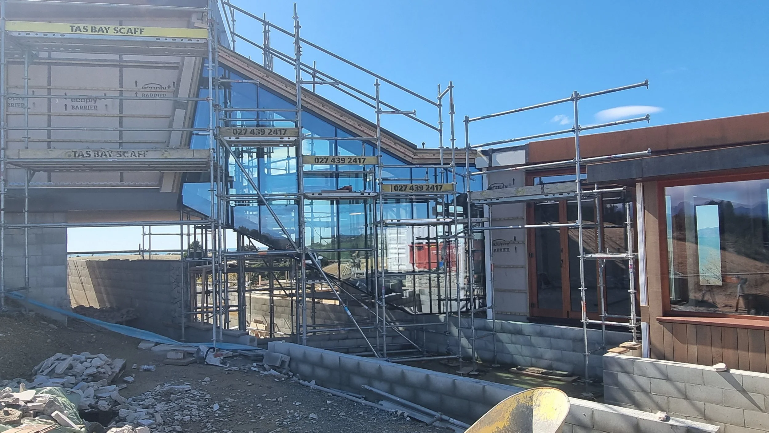 Glass stairwell, running from lower level to upper level across pool with glass base, new home Tasman Bay, Nelson by Waka Group Architecture