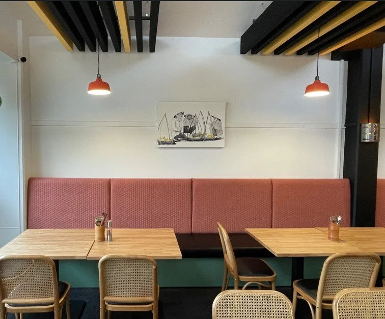 Muted colour - salmon and mossy green with subtle lighting in Idoo dining area designed by Waka Group