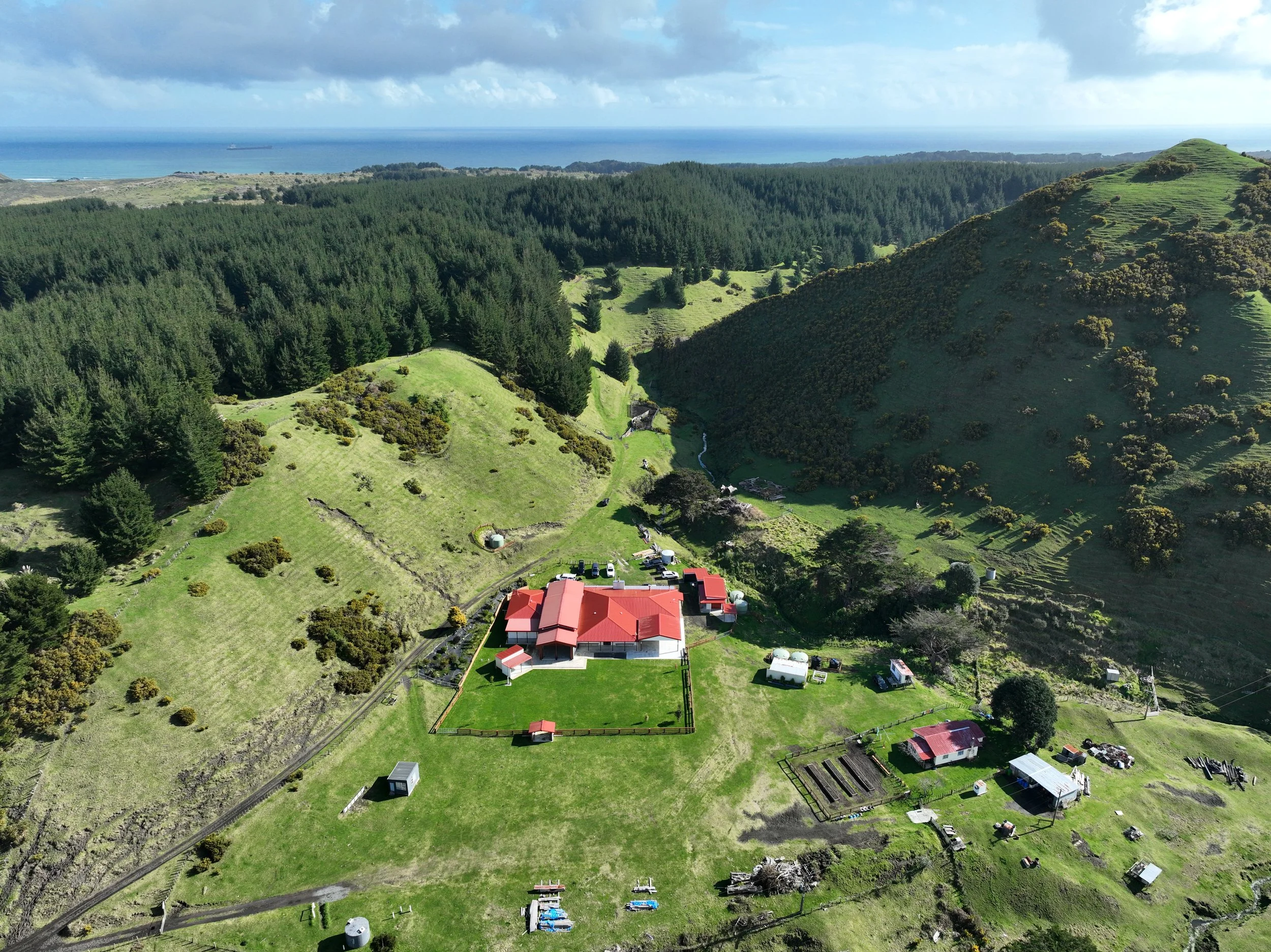 Ariel view of Te Kooraha Marae overloking vally and out to the west coast and ocean