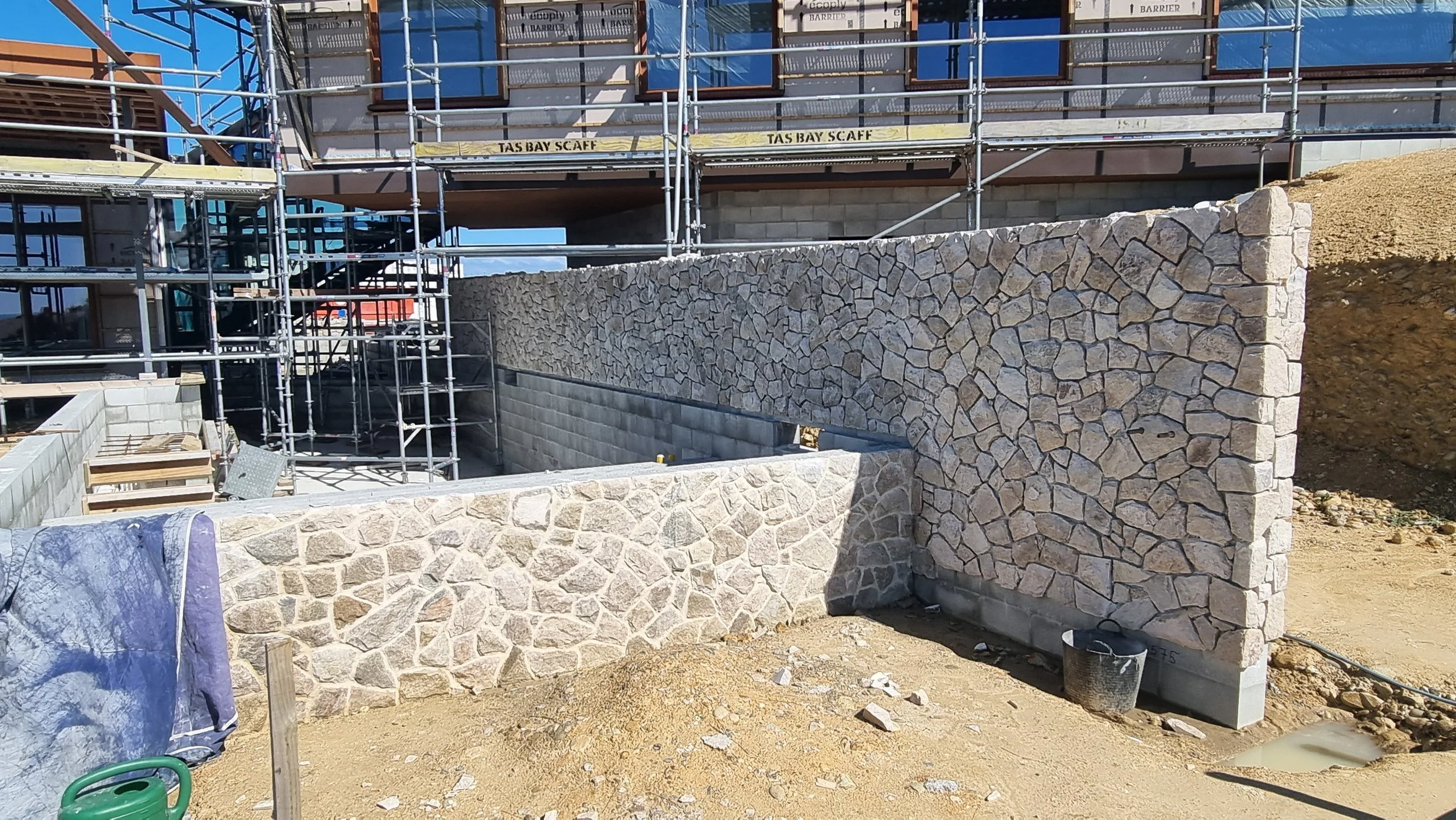 Stonework around swimming pool at new home in Tasman