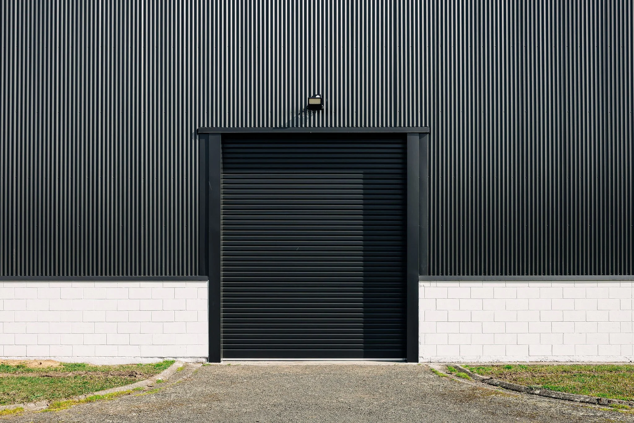 Close up of the new roller doors and new cladding, paint work at hopuhopu sports hangar in the Waikato