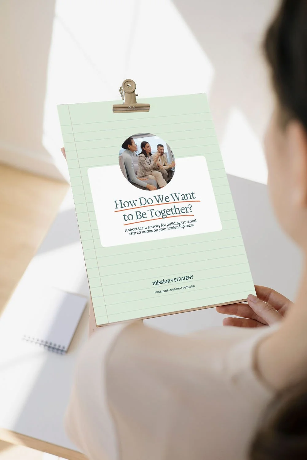 nonprofit leader holding copy of "how do we want to be together" activity guide