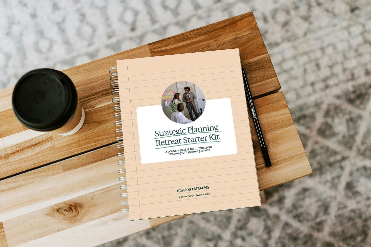 printed copy of strategic planning retreat starter kit resource for nonprofit leaders sitting on table