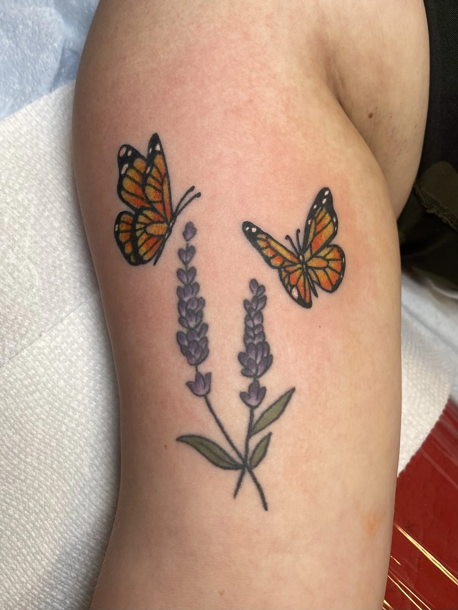 Monarch butterflies and lavender tattoo on an upper arm.jpg