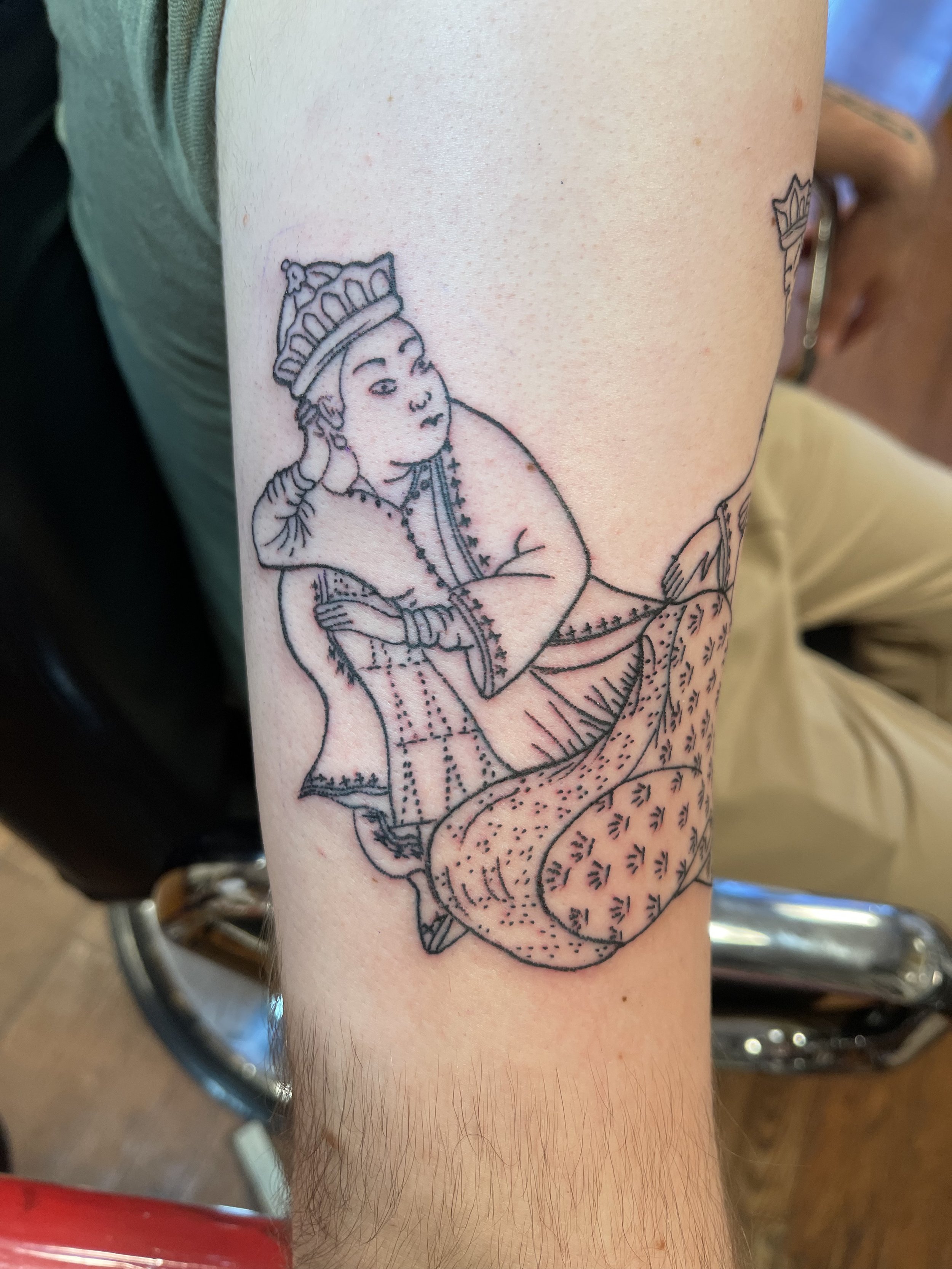 Japanese style linework tattoo of a traditional seated figure by Electric Lotus Tattoo in NYC
