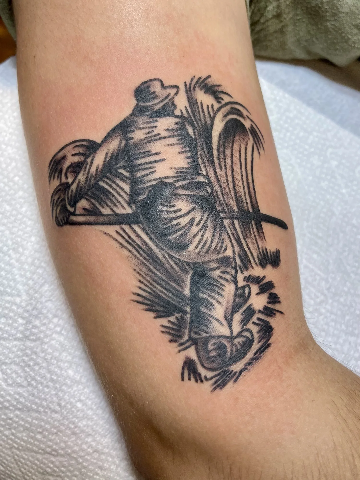 Woodcut style blackwork bird tattoo on an arm.jpg
