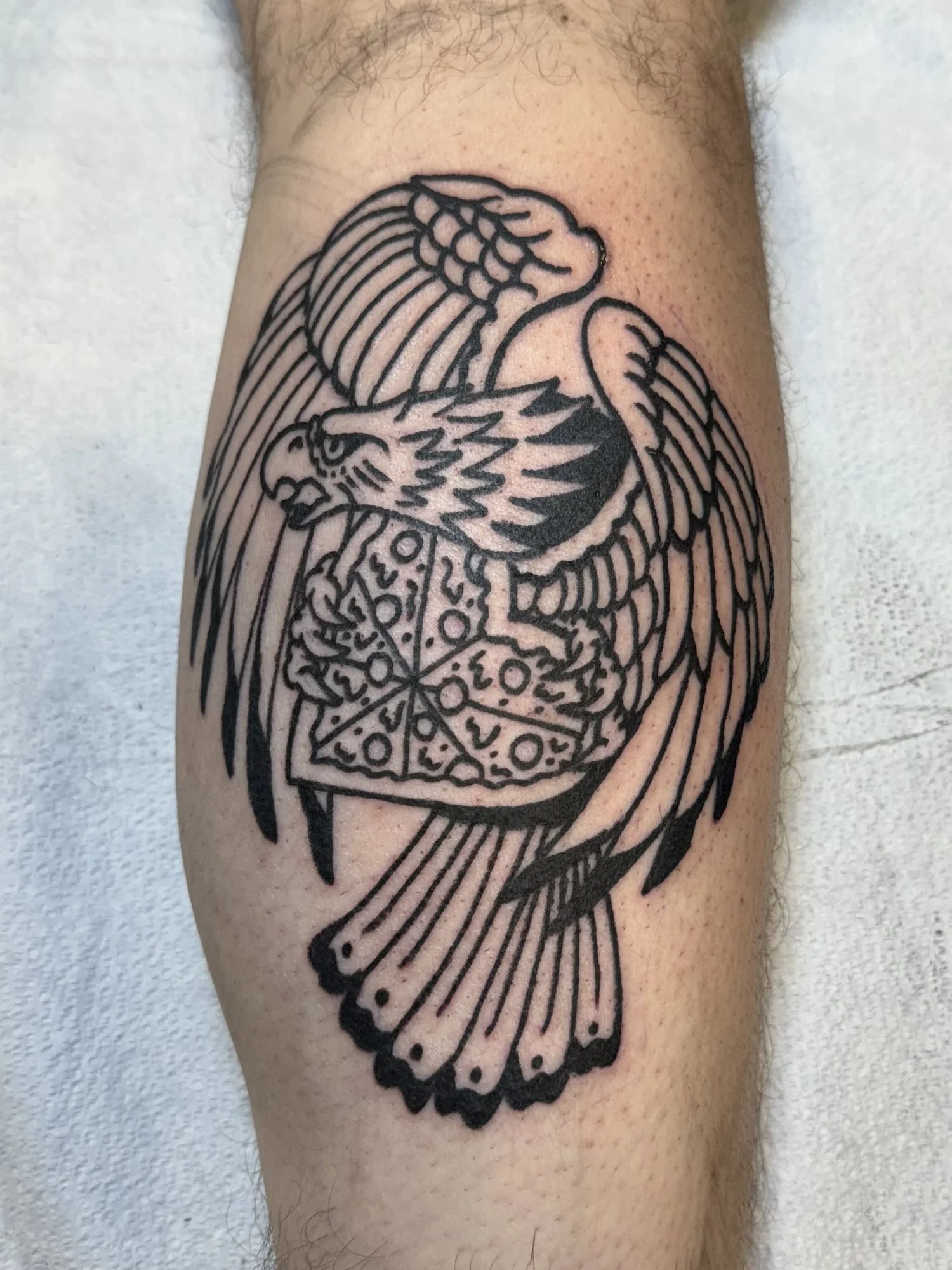 Ornamental blackwork eagle tattoo on an arm.jpg