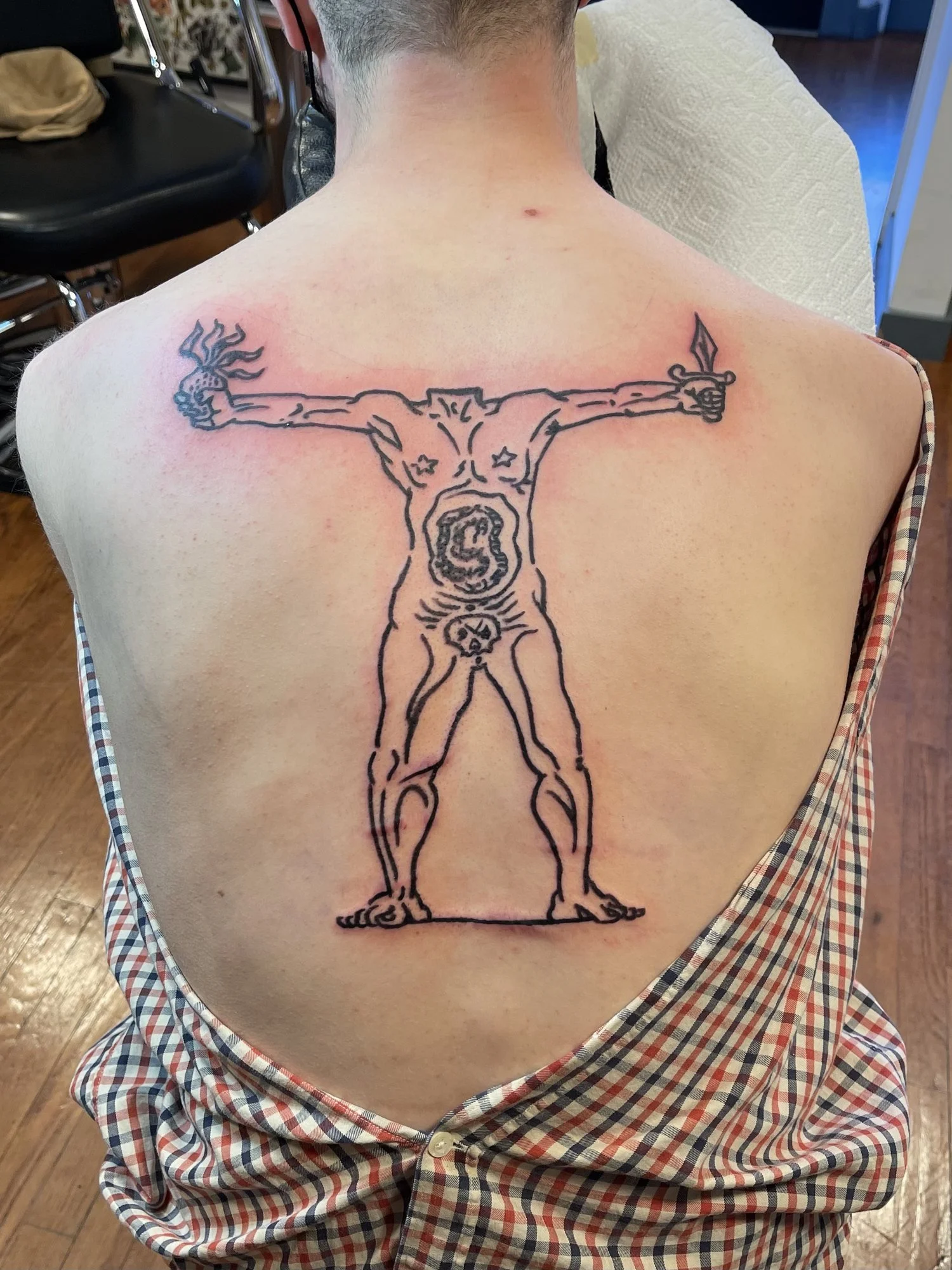 Large fine line figure tattoo across a full back.jpg