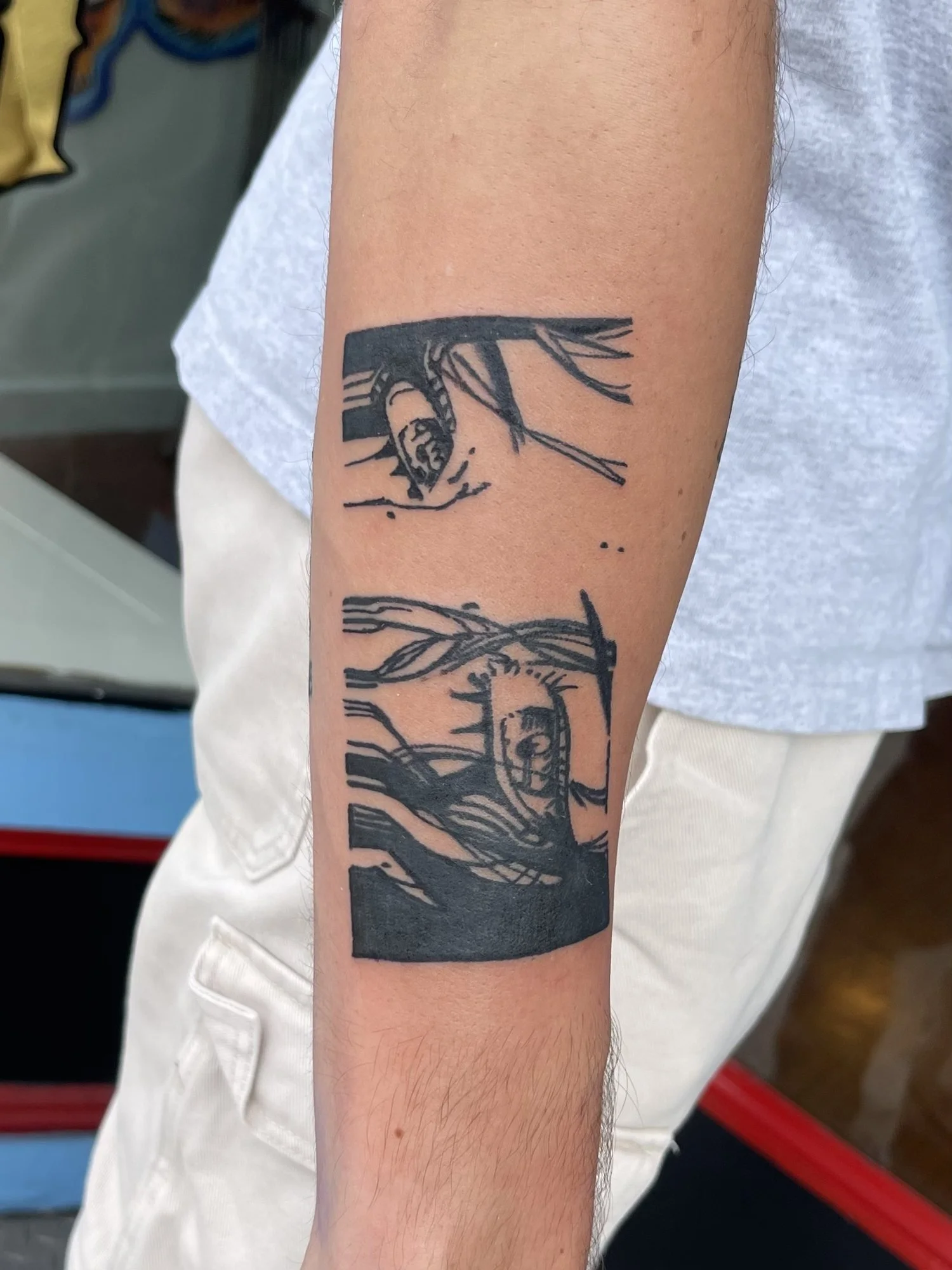 Woodcut style blackwork armband tattoo on a forearm.jpg
