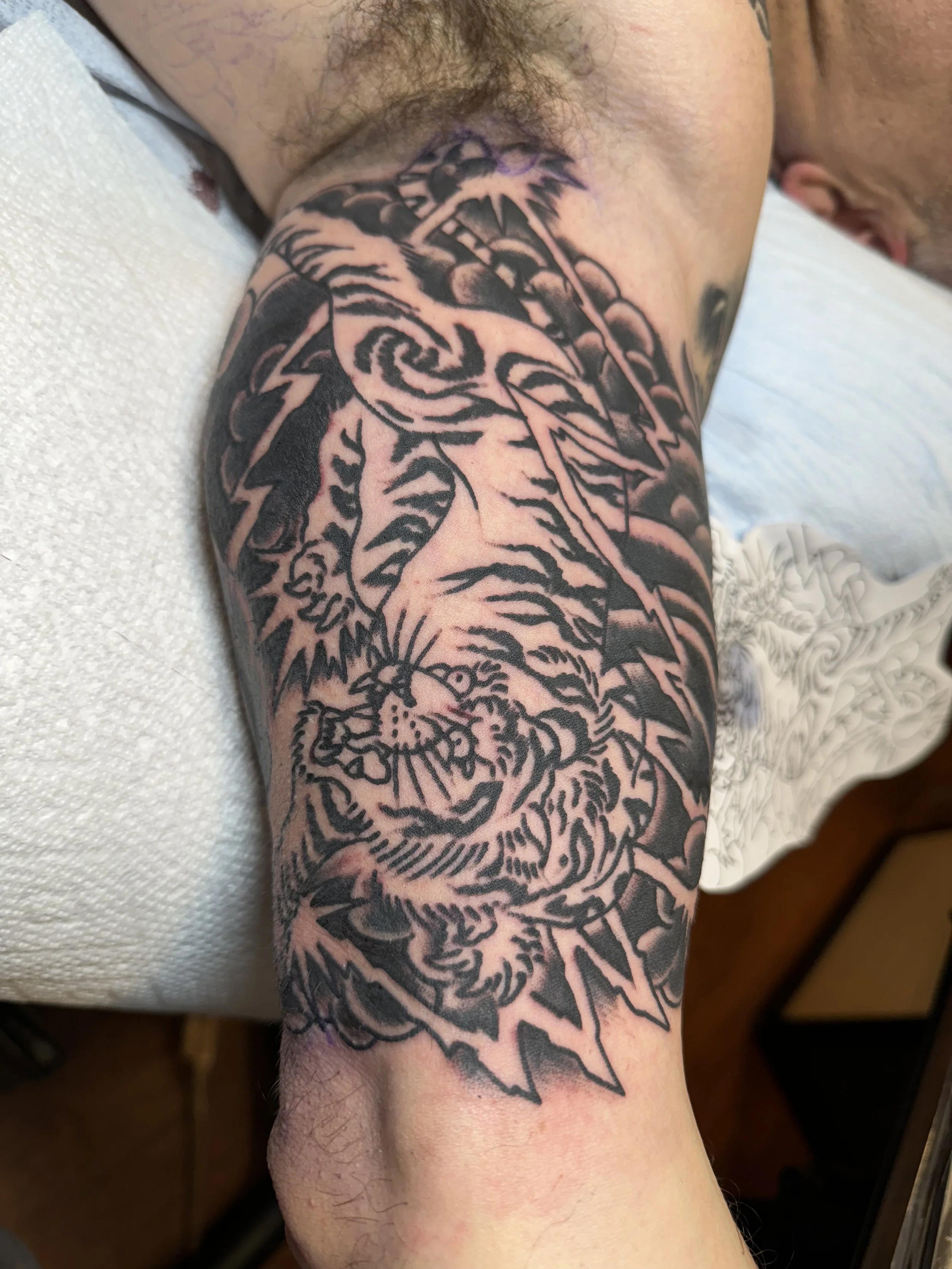 Japanese tiger and dragon tattoo in bold black shading by Electric Lotus Tattoo in NYC