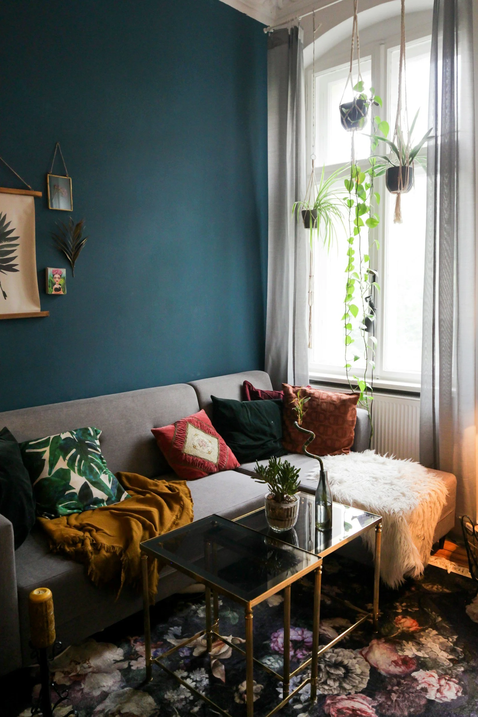 A beautiful living area with a lounge, coffee table, and colourful cushions.
