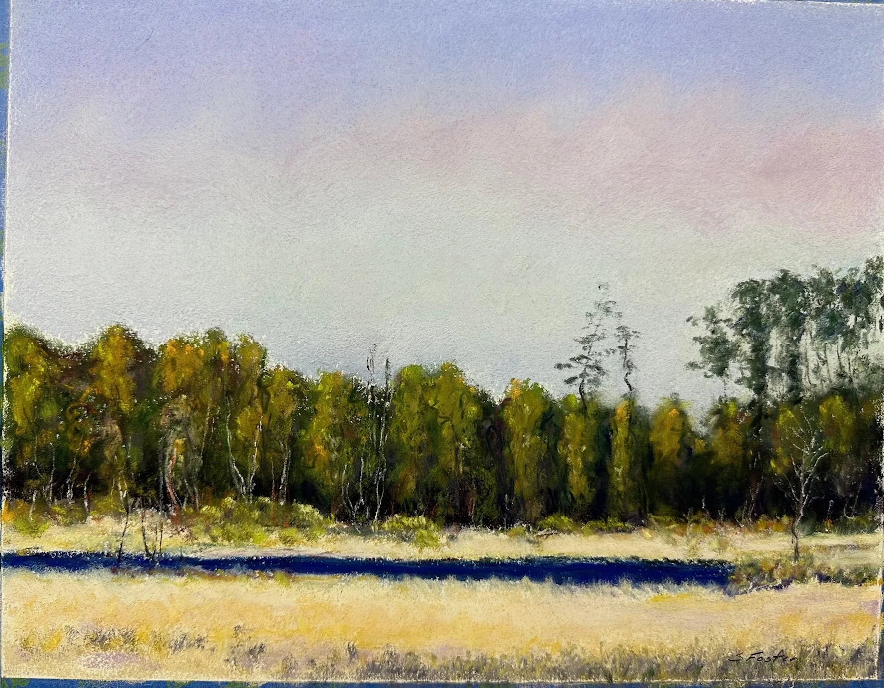 A landscape painting of a row of trees with yellow and green foliage, a yellow grassy field, a dark blue river, and a clear sky in the background.