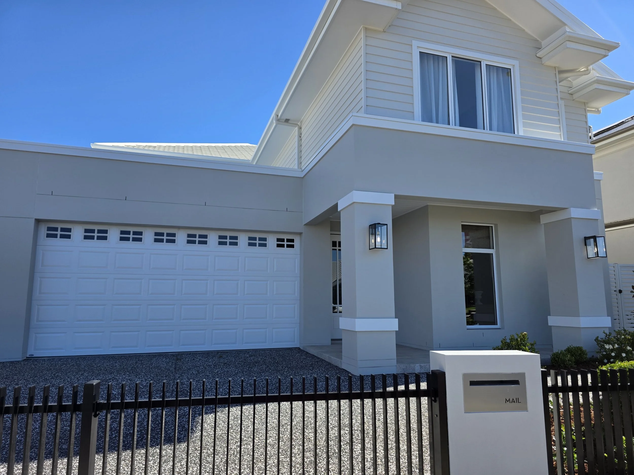 Modern Australian Hamptons exterior inspiration featuring white facade, neutral tones, stone detailing and classic coastal architectural elements