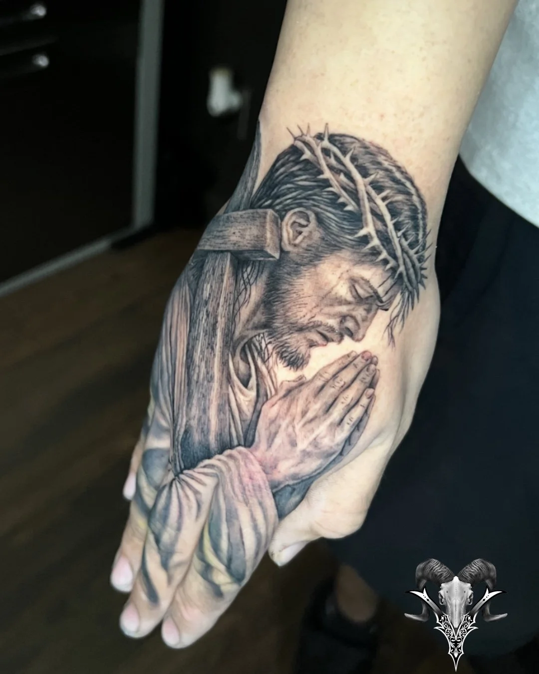 Black and grey realism tattoo of Jesus praying with a crown of thorns by Mi Vida Tattoos