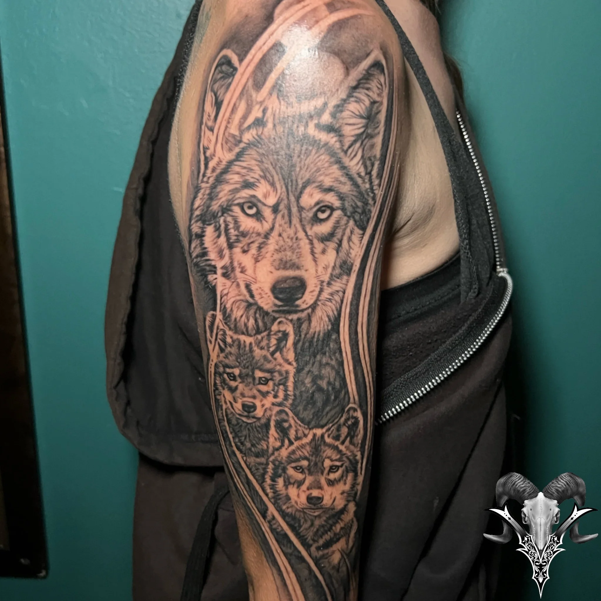 Black and grey wolf realism sleeve tattoo by Mi Vida Tattoos