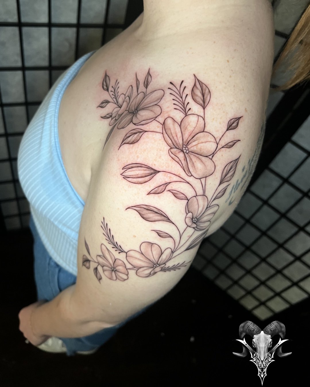 Fine line floral shoulder tattoo by Jose Lopez at Mi Vida Tattoos