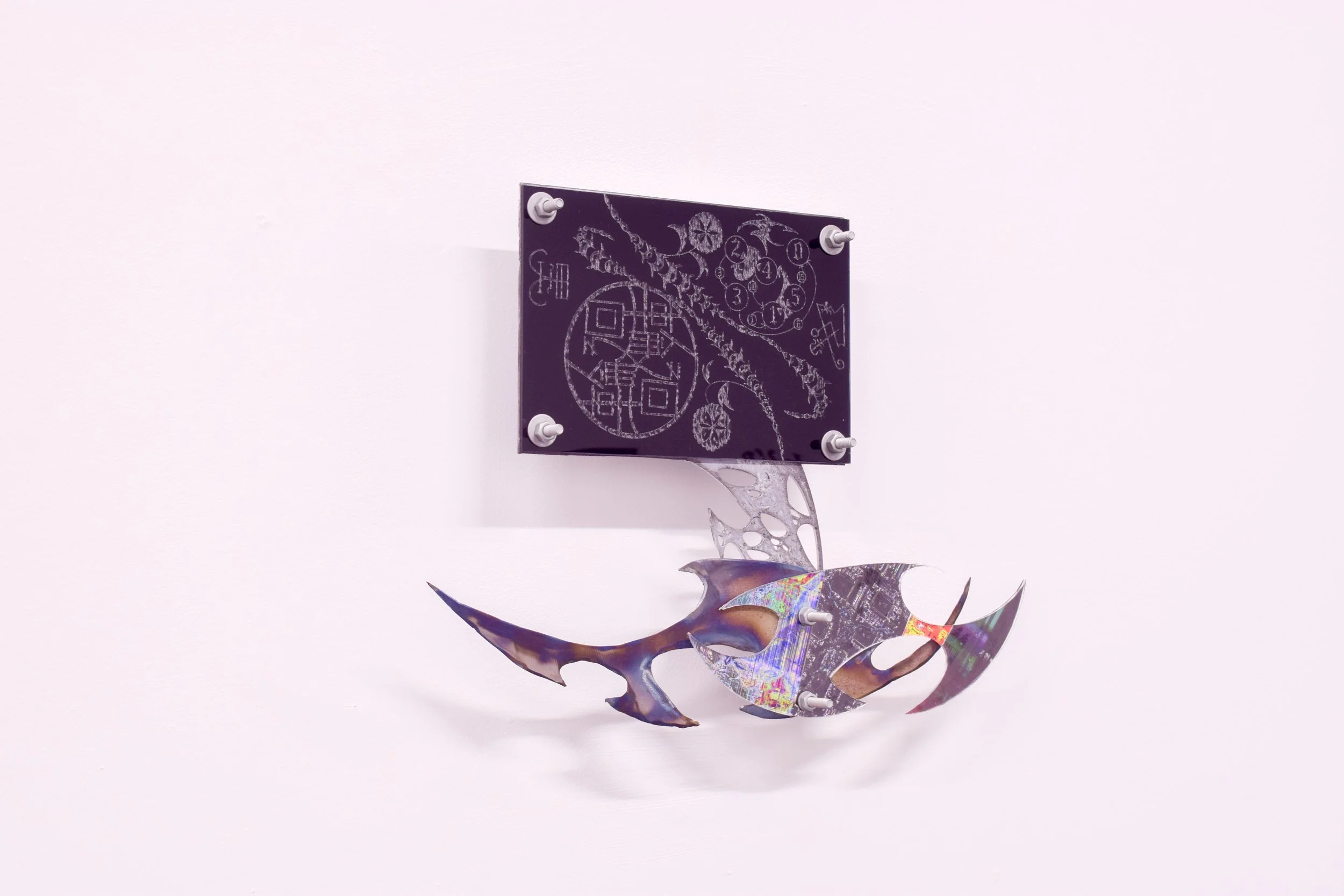 Mixed media art piece featuring a holographic, fish-shaped object with a purple square panel mounted on a plain white wall. The panel has white line drawings and symbols, some resembling a clock and geometric designs.