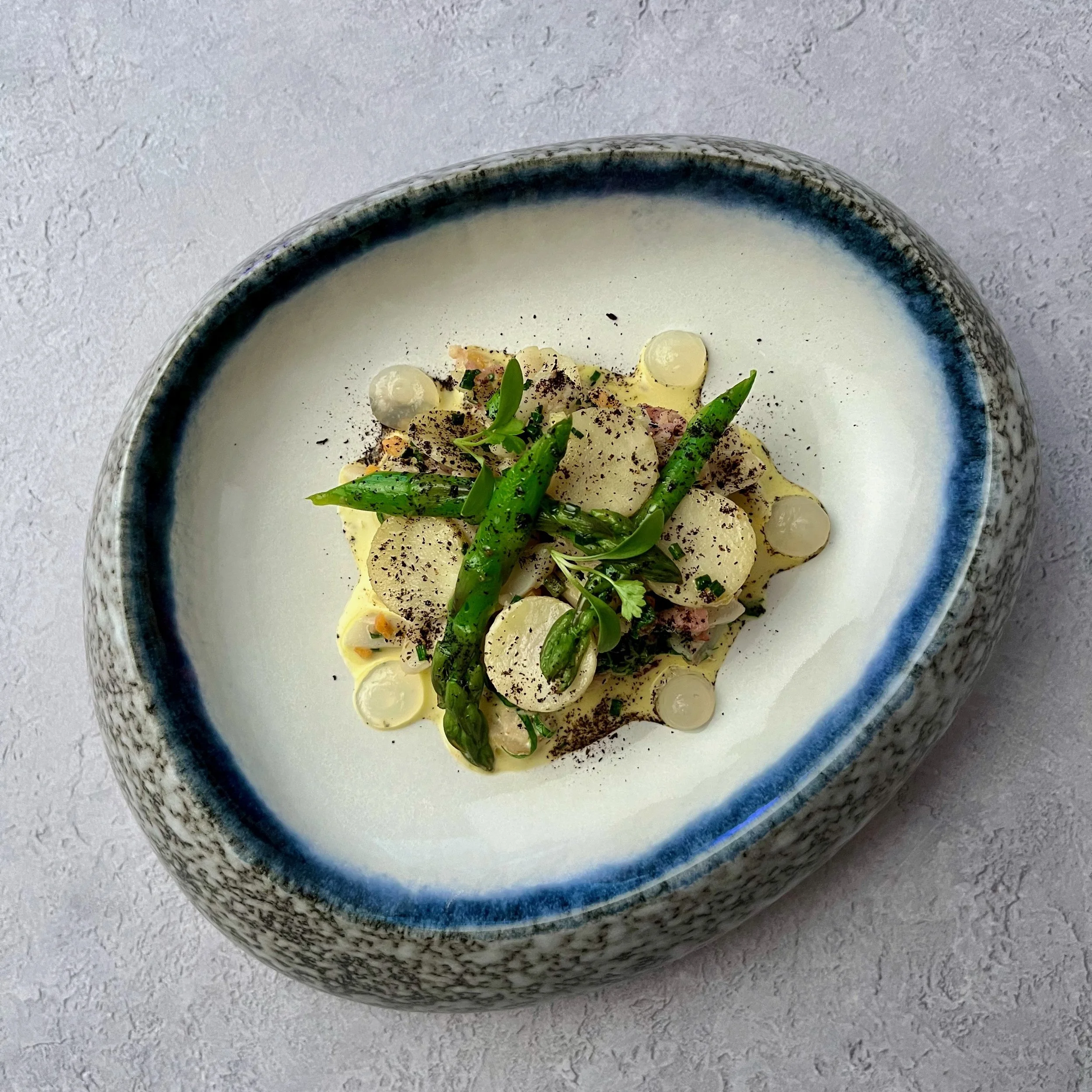 Razor clams with asparagus artichoke, crispy ham and lemon