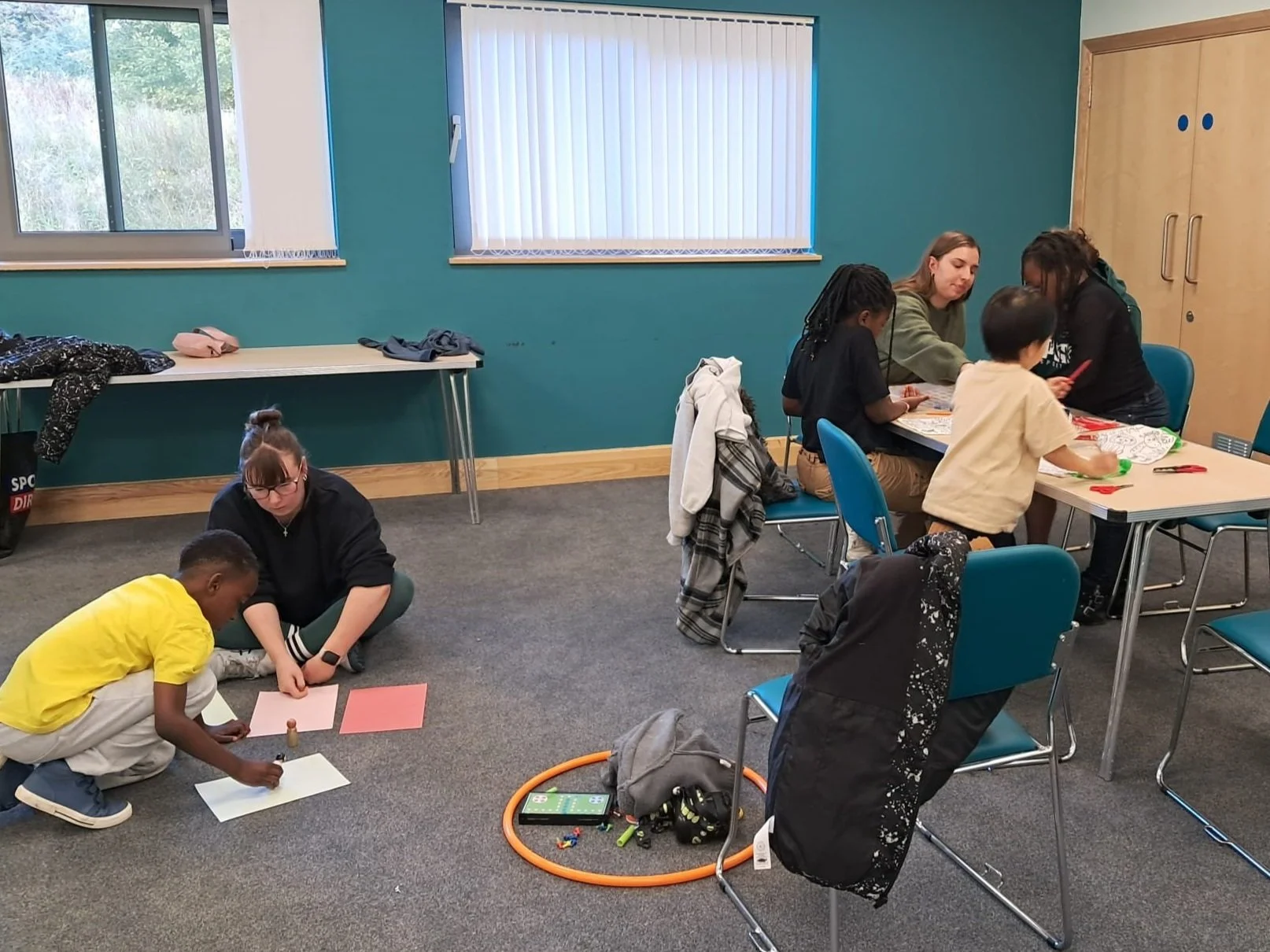 Children engaging in arts and crafts activities in a brightly lit room as part of the church day away.