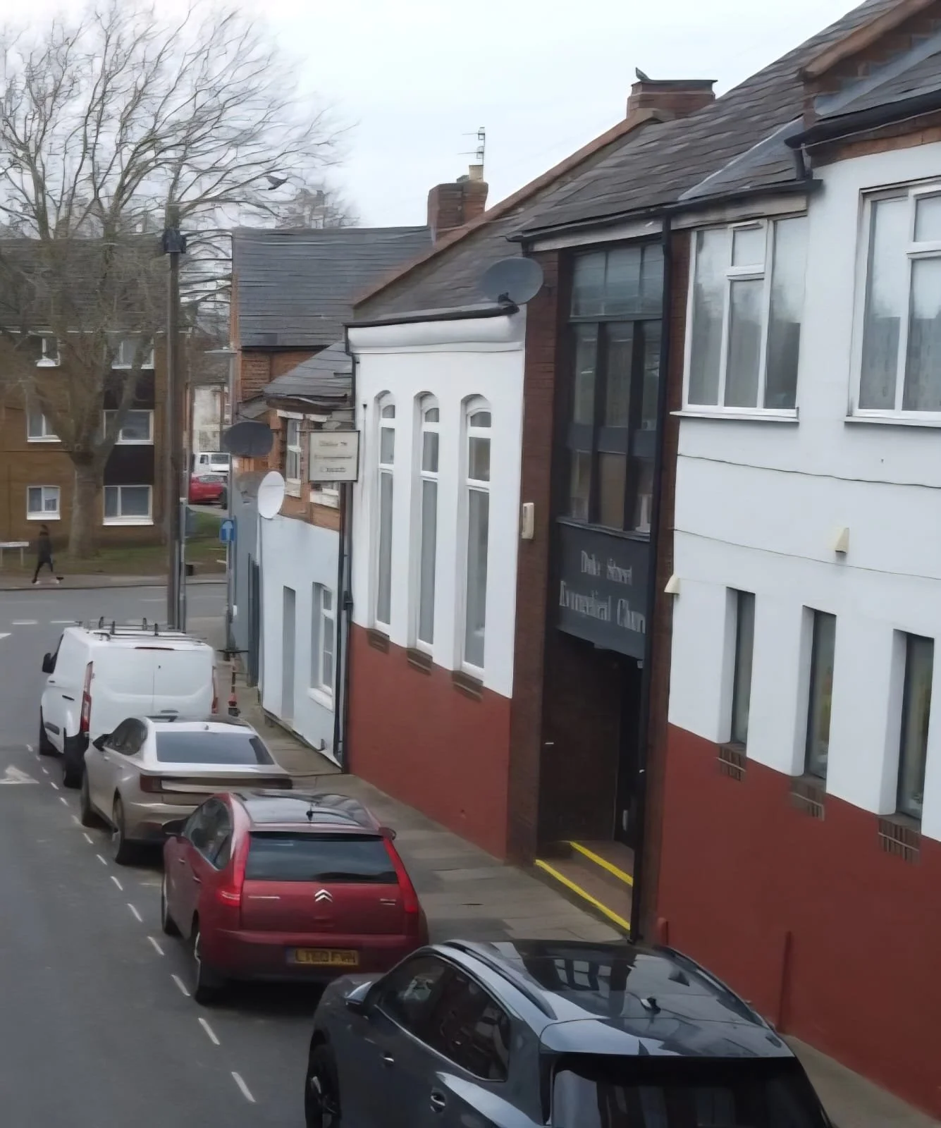 Street view of the front of the Duke Street Evangelical Church, painted in terracotta red and white.