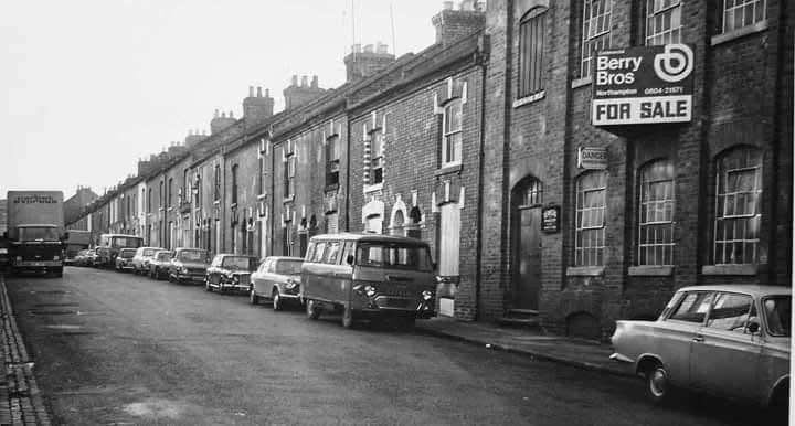 A black and white picture of Duke Street showing the terrace houses that once stood on the opposite side of the road to the church