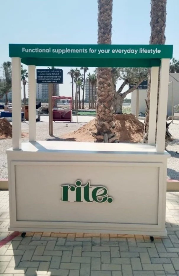A promotional stand with a green sign that reads, 'Functional supplements for your everyday lifestyle,' advertising Rite Aid.