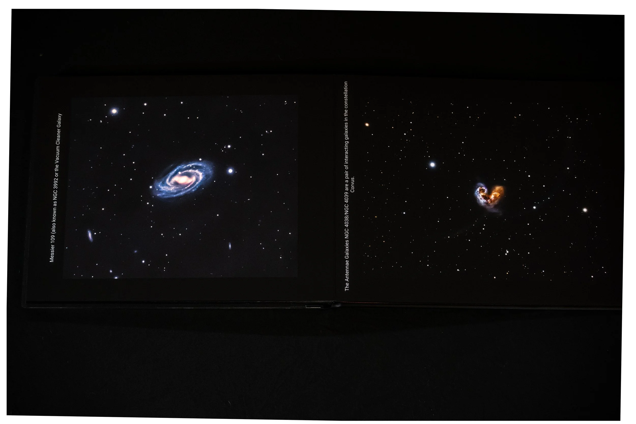 Open book showing images of galaxies and nebulae with labels and descriptions.