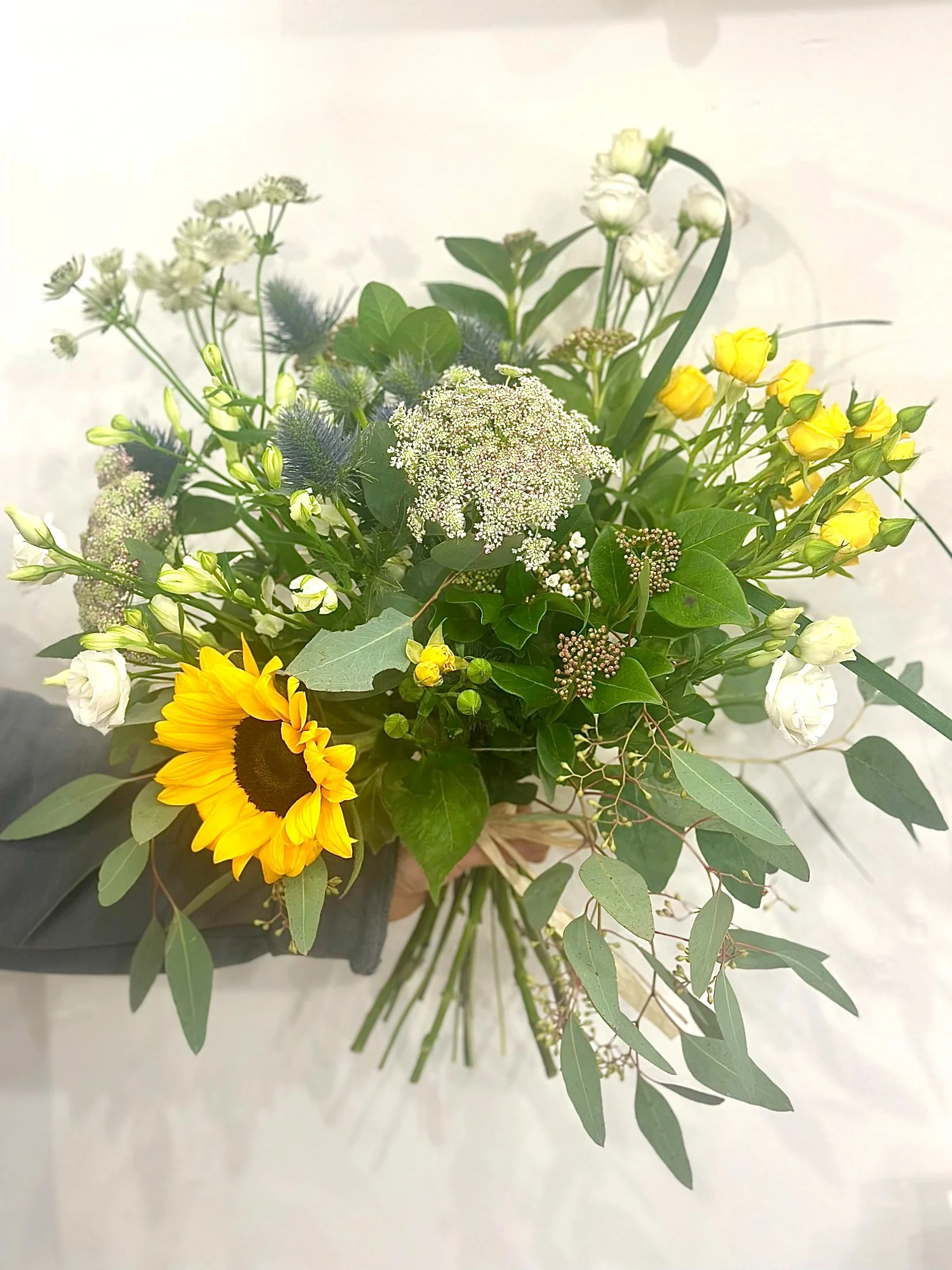 Buttery Garden bouquet featuring sunny yellow and soft cream flowers in a natural, garden-inspired style