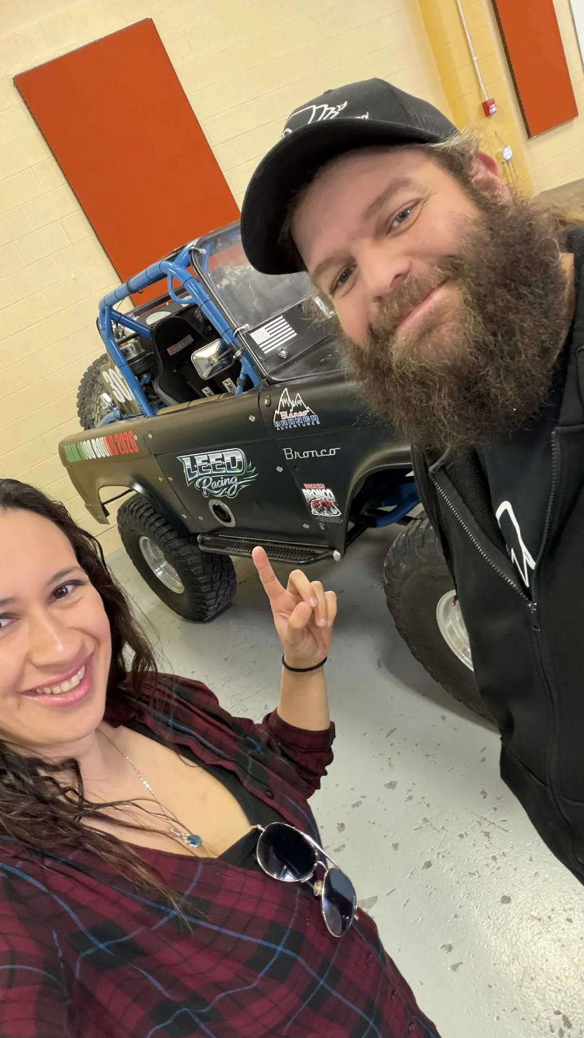 Derick and Monica standing beside the race Bronco.