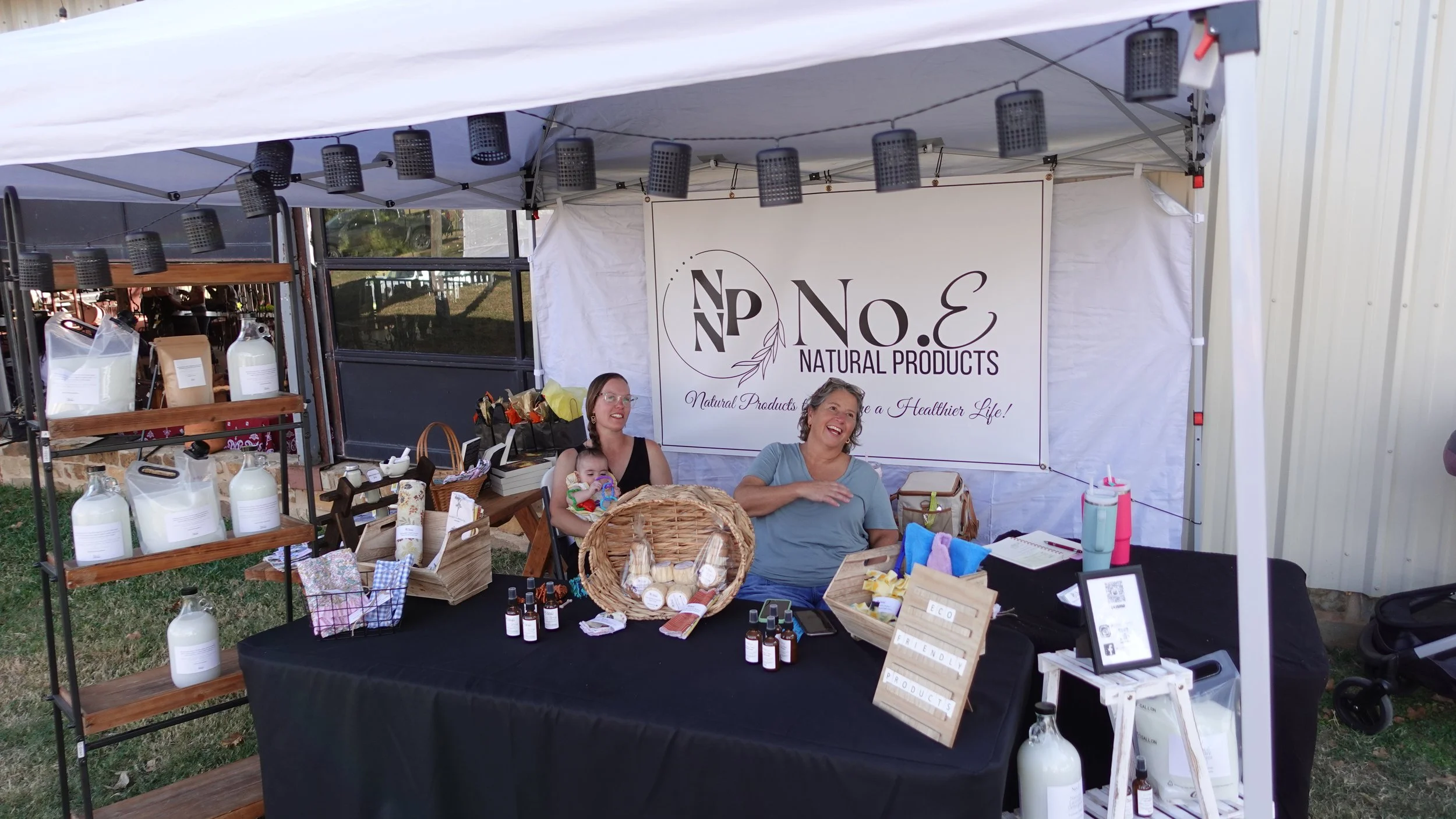 women smiling at natural products booth