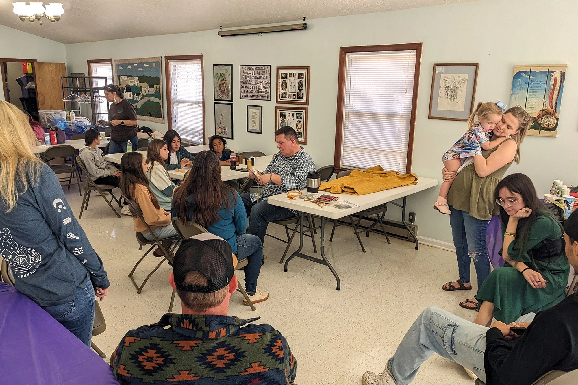 Matt Latimer of the Monacan Indian Nation teaches the significance of a medicine bag while youth and parents learn to make their own. The visit was used to gain feedback on the importance of a youth center at Laurel Cliff.